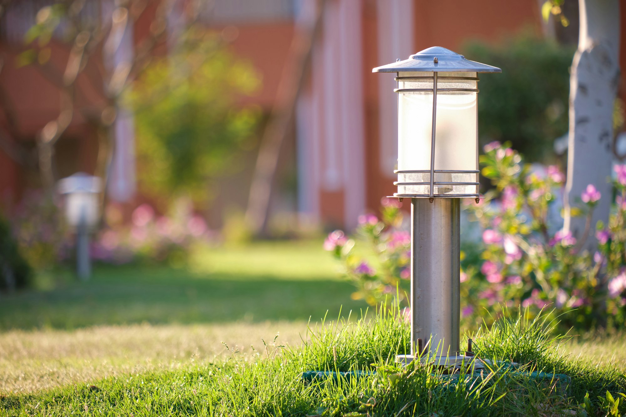 Outdoor lamp on yard lawn for garden lighting in summer park